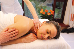 Woman on a bed getting a massage